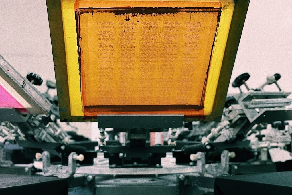 A yellow screen in an automatic screen printing press.