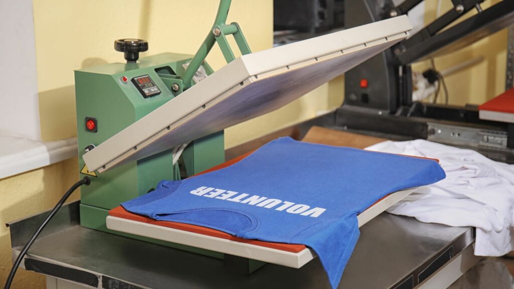 A printed shirt lying on an open heat press