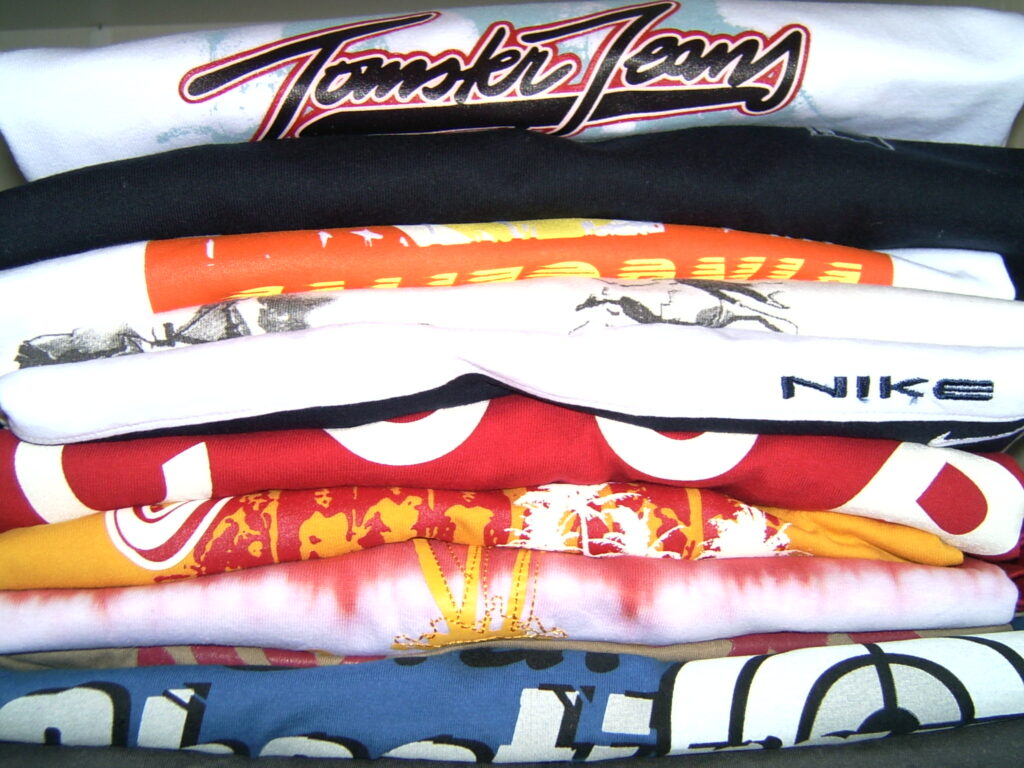 A stack of shirts with various designs
