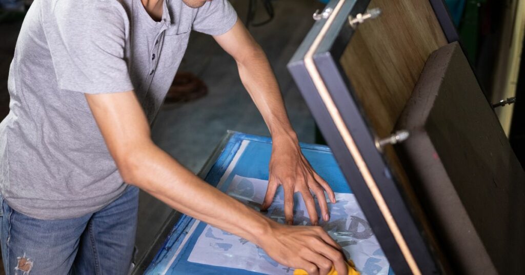 A person handling a screen printing product