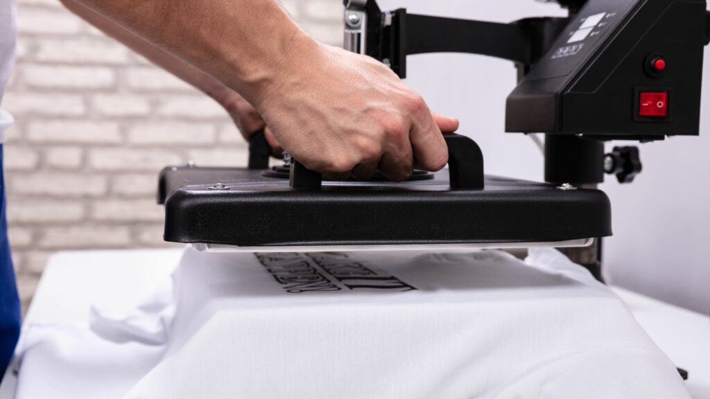 A person using a heat press on a shirt