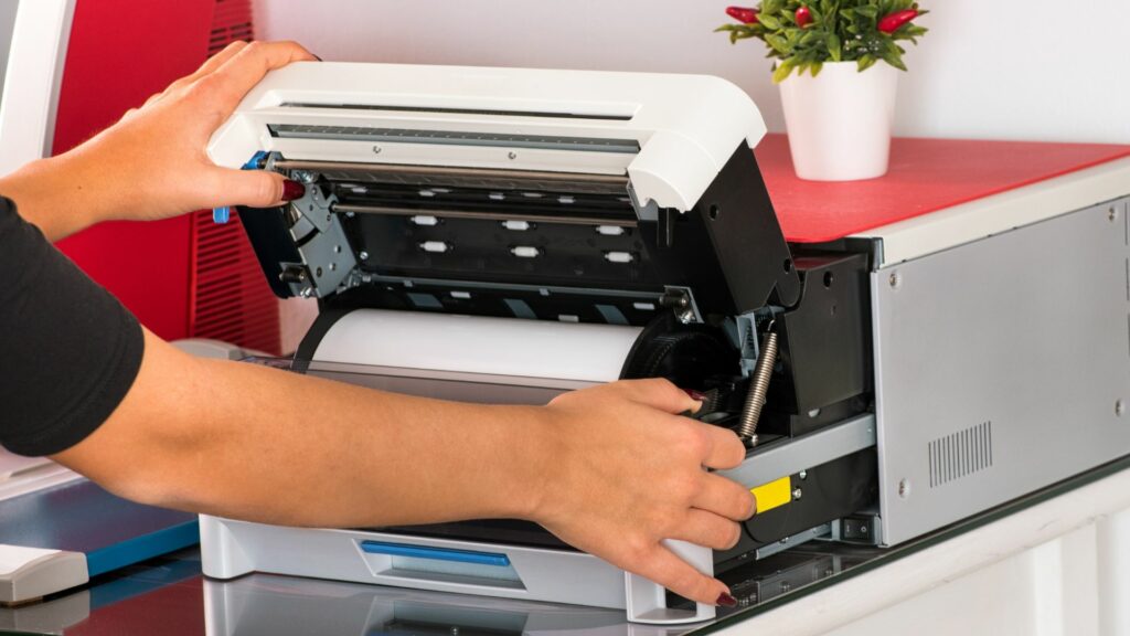 A man inspecting a dye sublimation printer