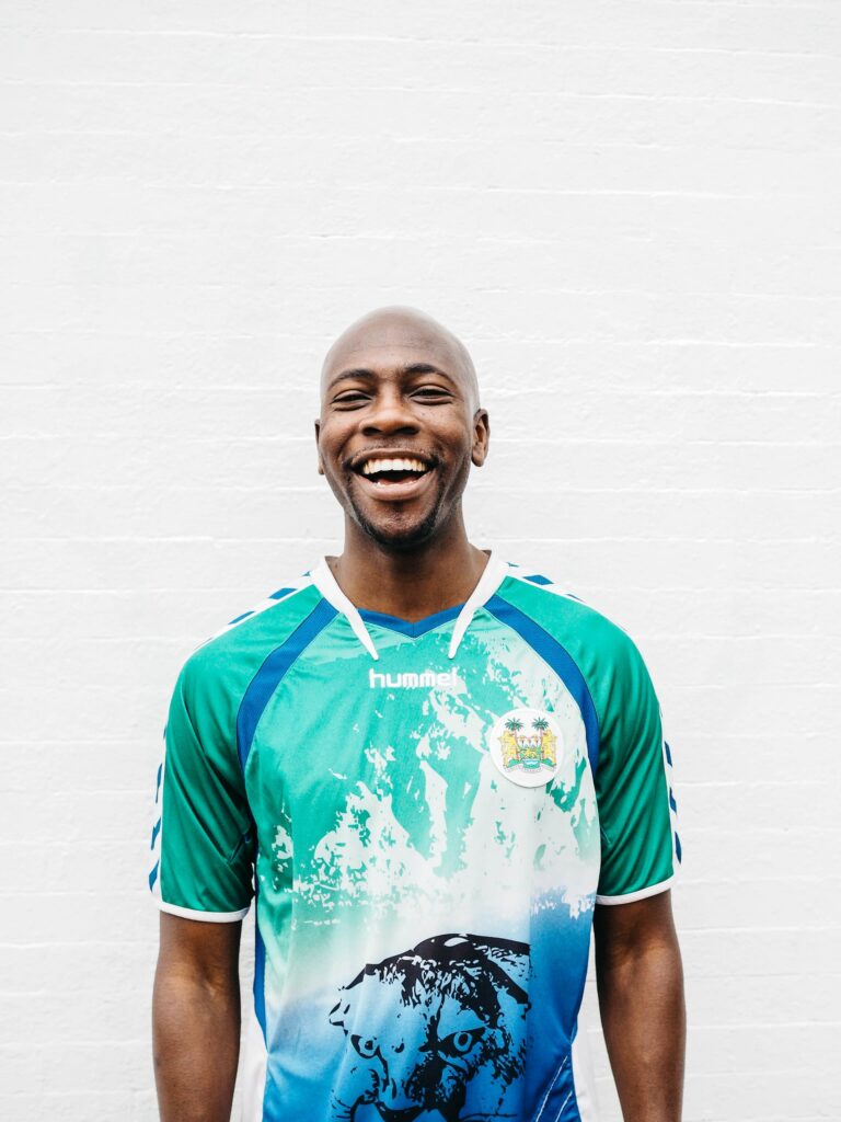 A smiling man wearing a colorful jersey