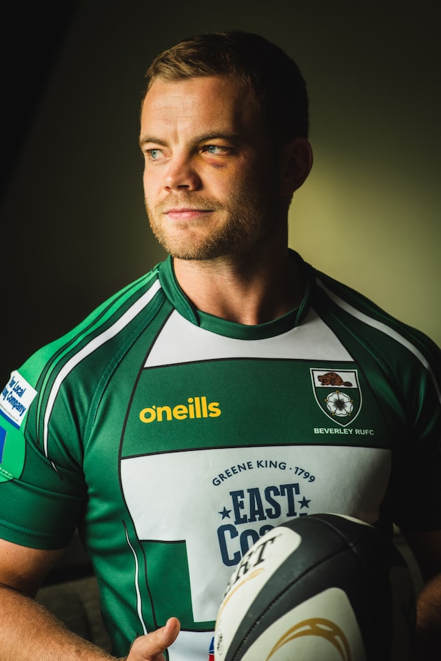A man in a green and white jersey