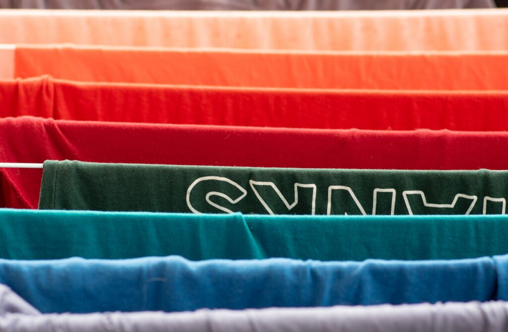 A row of hanging colored shirts