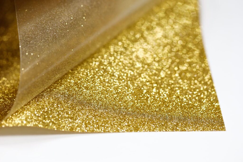 A glittery gold heat transfer vinyl sheet