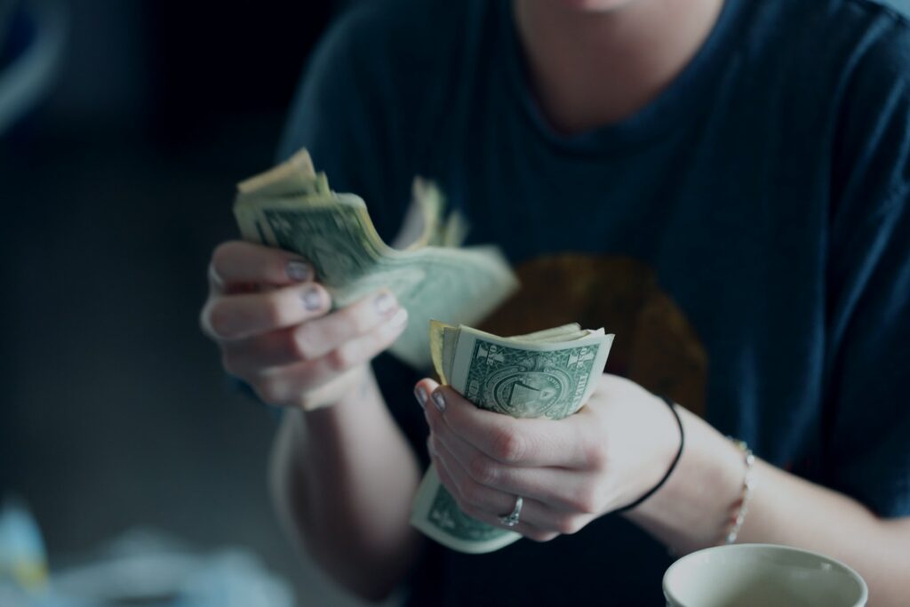 A woman counting cash in her hands