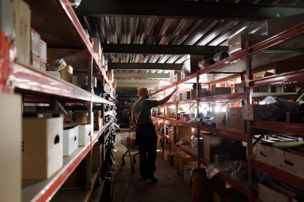 A man checking shelves in a warehouse