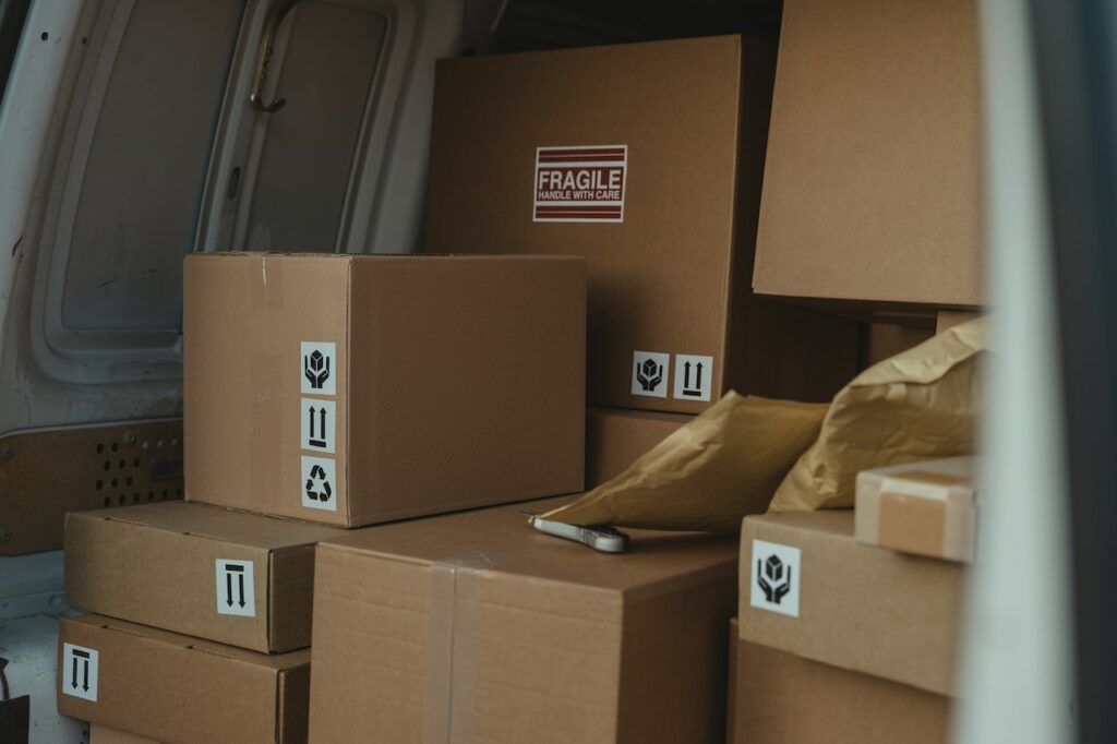 A collection of sealed packages in a delivery van's trunk