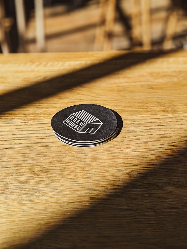 A custom made coaster rests atop a wooden table
