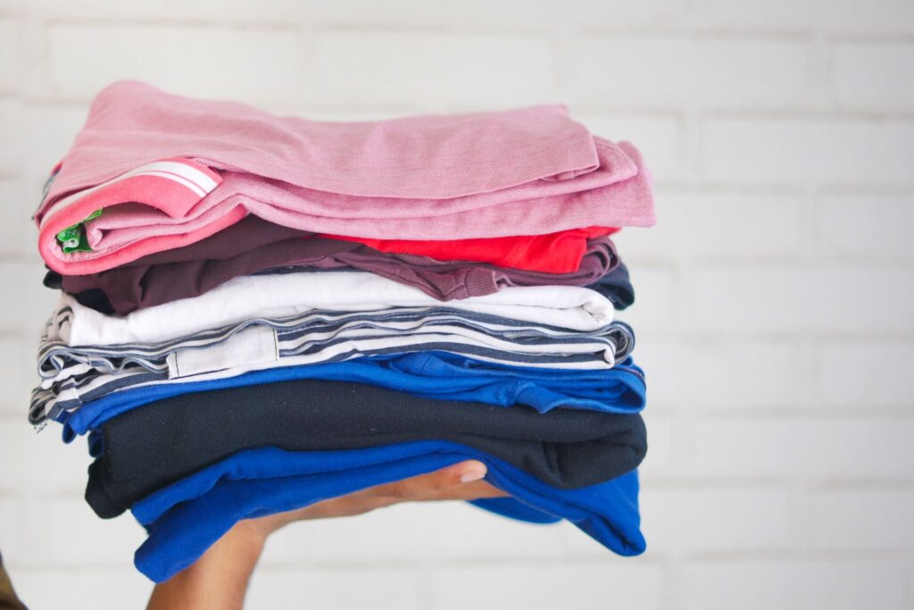 A stack of shirts on someone's hand