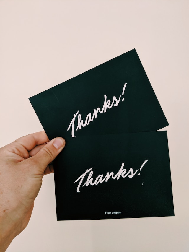 Thank you cards in a person's hands