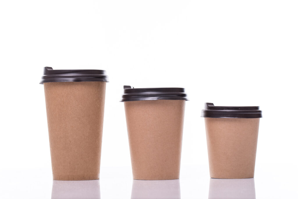covered paper coffee cups different sizes isolated white